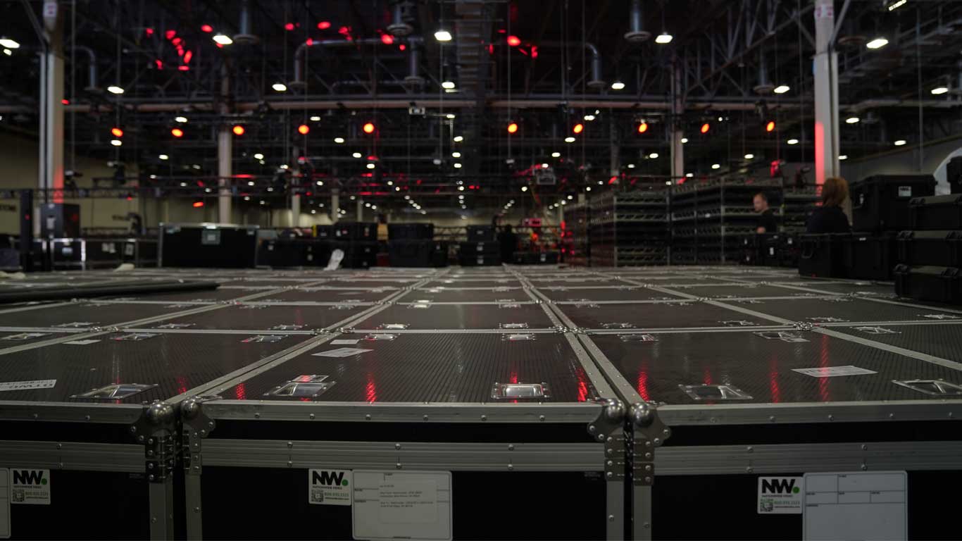 a photo background of an event showsite during setup and what looks like an infinite view of ATA road cases